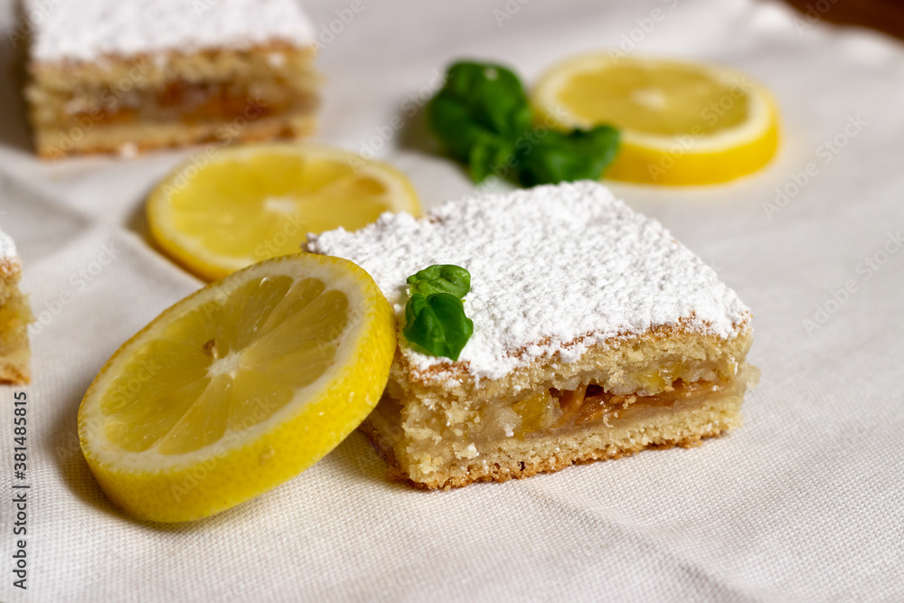 Homemade lemon pie with lemon slices alongside Homemade lemon pie with lemon slices alongside