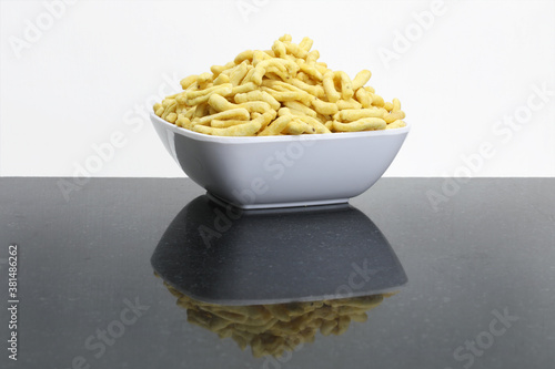 Indian snacks food gathiya sev in white bowl in white background. photo