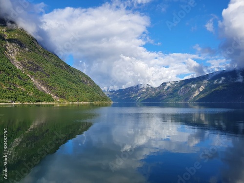 reflection of the sky and mountains in the blue water of the fjord - Eidfjord