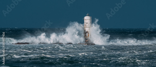 The lighthouse of the Mangiabarche shrouded by the waves of a mistral wind storm © ivan canavera