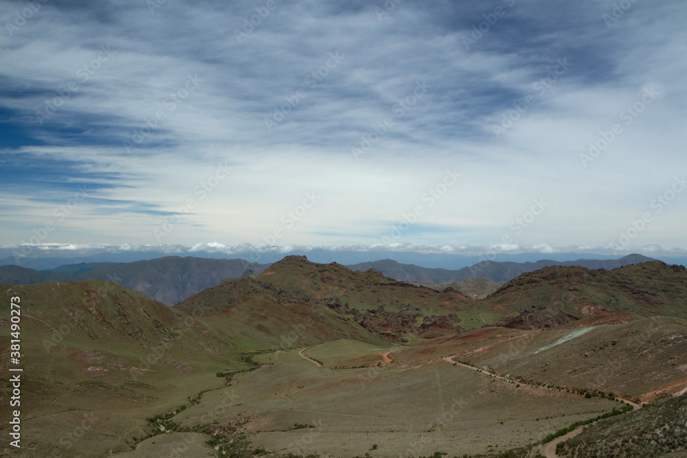 Aerial view of the enchanted Valley in Salta, Argentina. The green meadow, valley and hills under a beautiful blue sky with clouds.