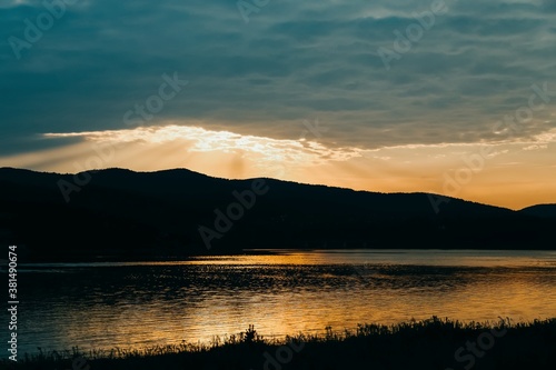 Beautiful golden sunset reflected in lake water. Lake Mucharz. Jezioro Mucharskie, Poland