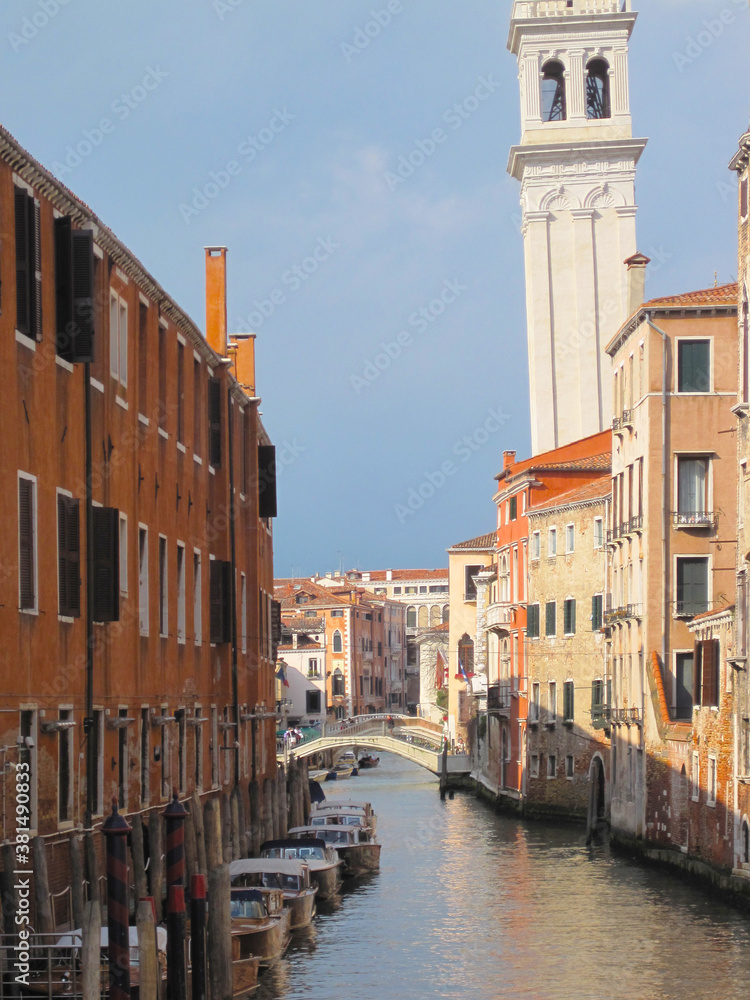 Venice, topical internal Venetian canal view in a sunny day in the evening, topical Venetian Calle and building, portrait crop