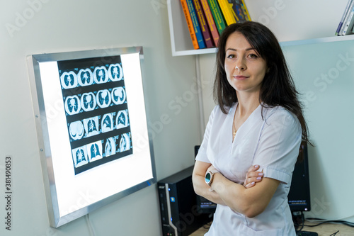 Doctor explaining an x-ray image near enlighted board. photo