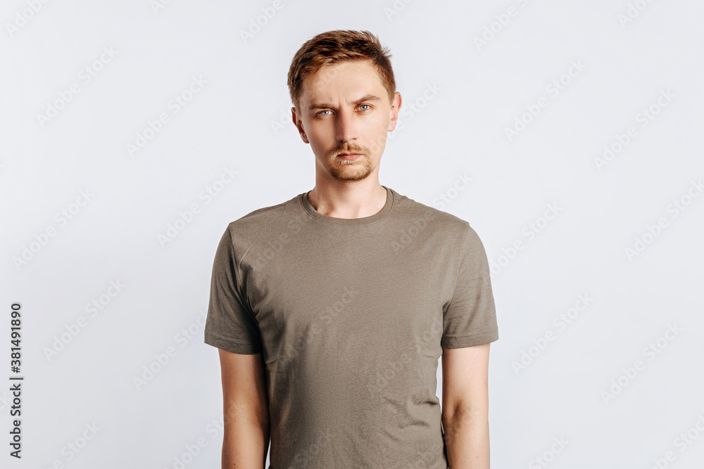 Young handsome brunet man with beard frowning and displeased on white isolated background Young handsome brunet man with beard frowning and displeased on white isolated background