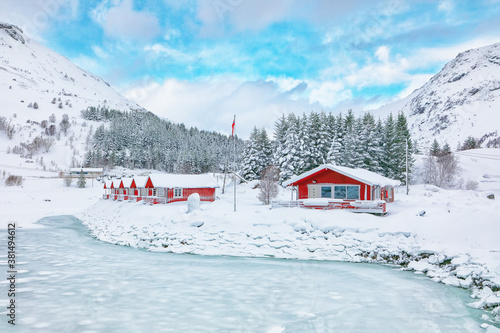 Wonderfull winter scenery with traditional Norwegian red wooden houses on the shore of Rolvsfjord on Vestvagoy island