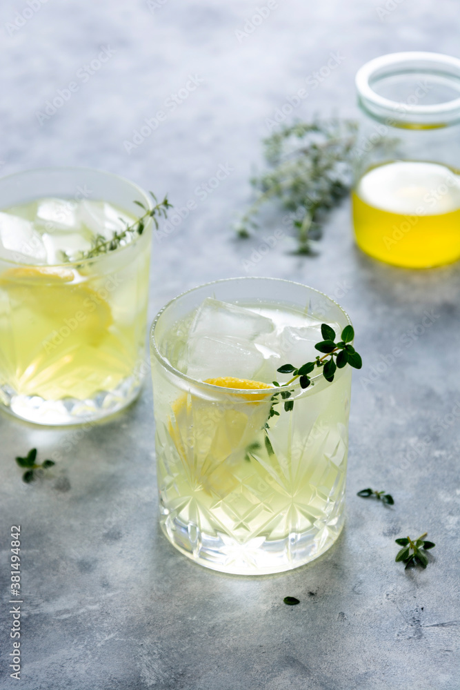Glass of lemon fresh summer drink in glass. Soda lemonade drink with herb. Glass of lemon fresh summer drink in glass. Soda lemonade drink with herb.