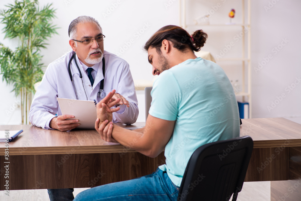 Injured young man visiting old doctor Injured young man visiting old doctor