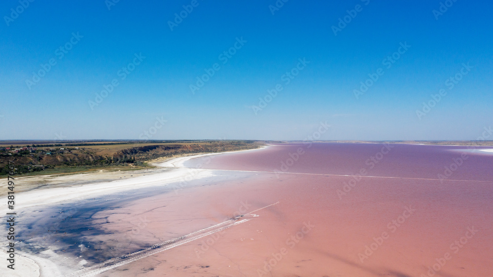 Aerial drone top down photo of a natural pink lake Kuyalnik in Odessa, Ukraine. Lake naturally turns pink due to salts and small crustacean Artemia in the water. This miracle is rare occurrence. Aerial drone top down photo of a natural pink lake Kuyalnik in Odessa, Ukraine. Lake naturally turns pink due to salts and small crustacean Artemia in the water. This miracle is rare occurrence.