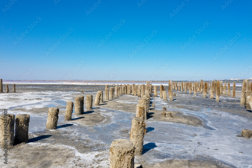 Salt pink lake landscape in summer sunny day Kuyalnik in Odessa, Ukraine. Saline with vivid colors and clear sky. Water has receded far into result of strong summer drought. Ecological catastrophy Salt pink lake landscape in summer sunny day Kuyalnik in Odessa, Ukraine. Saline with vivid colors and clear sky. Water has receded far into result of strong summer drought. Ecological catastrophy