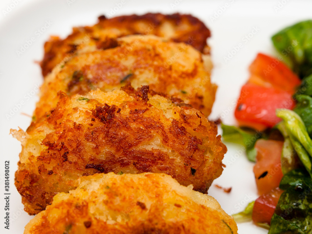 Pasteis de bacalhau - portuguese cod fritters with salad Pasteis de bacalhau - portuguese cod fritters with salad