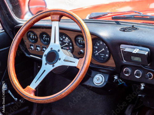 The steering wheel and dashboard of an antique classic car