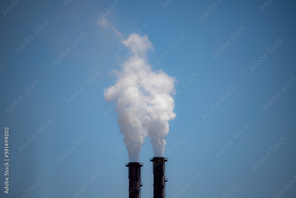 Factory chimney with dirty smoke emitting nature