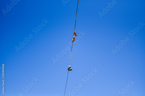 Sneakers suspended on a wire