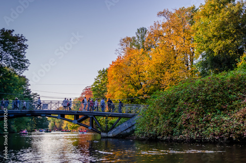 Bridge in autumn Park by the lake. Walk on the boat.