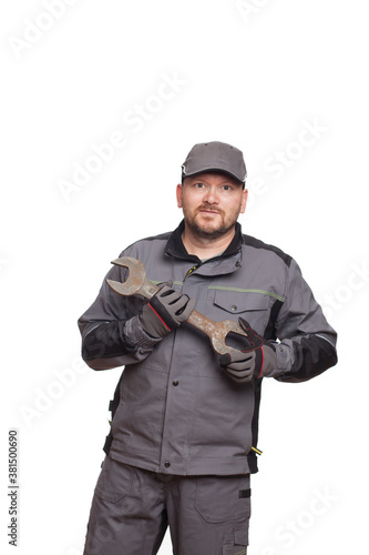An aged 40 auto mechanic holding a repair wrench isolated on a white background