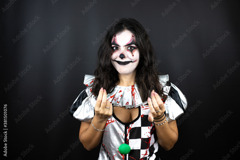 woman in a halloween clown costume over isolated black background doing money gesture with hands, asking for salary payment, millionaire business woman in a halloween clown costume over isolated black background doing money gesture with hands, asking for salary payment, millionaire business