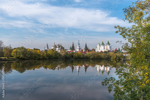 Izmailovo Kremlin and its reflection in a pond in early autumn. View from the side of Izmailovsky Island © Eselena