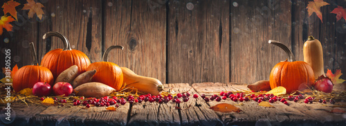 Thanksgiving And Harvest - Pie Pumpkins, Sweet Potatoes, Squash And Cranberries On Harvest Table With Wood Background