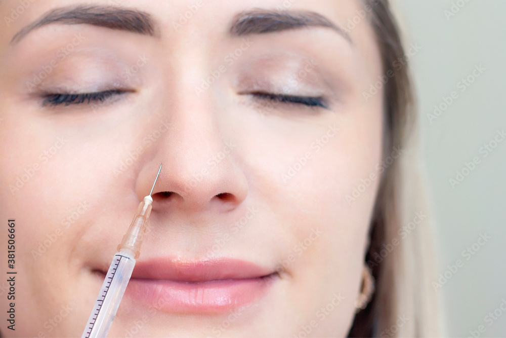 young woman receiving cosmetic injection of botox, close up. Woman in a beauty salon. Plastic Surgery Clinic. young woman receiving cosmetic injection of botox, close up. Woman in a beauty salon. Plastic Surgery Clinic.