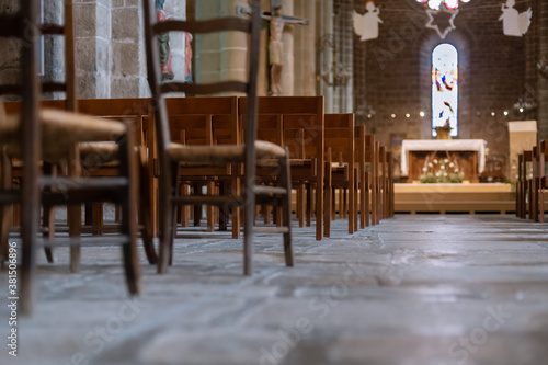 Row of wooden chairs inside a church in France. © o1559kip