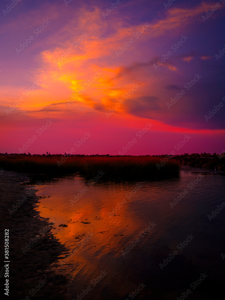 Dramatic Pink Seascape and Reflections on the Bay Water at Twilight on Cape Cod