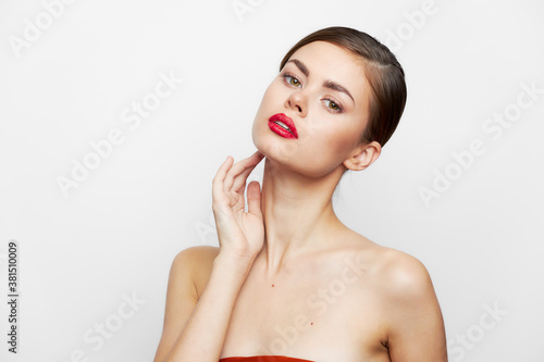 Woman with bare shoulders Clean skin and red lips elegant style bright makeup