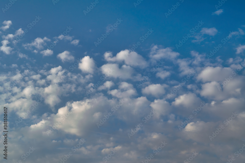 White cumulus clouds against a bright blue summer sky. White cumulus clouds against a bright blue summer sky.