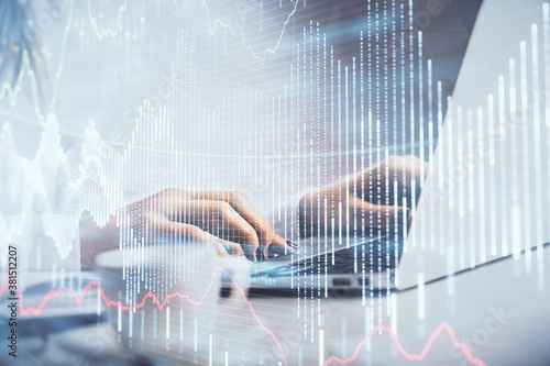 Double exposure of woman hands working on computer and forex graph hologram drawing. Financial analysis concept.