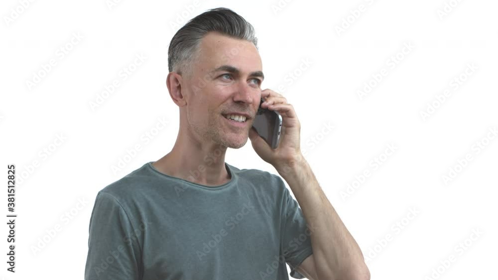 Handsome middle-aged slim guy with bristle and grey hair, talking on mobile phone, smiling and nodding, agree with someone, saying yes with happy expression, white background Handsome middle-aged slim guy with bristle and grey hair, talking on mobile phone, smiling and nodding, agree with someone, saying yes with happy expression, white background