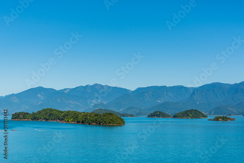 View of blue paradise formed by ocean, islands and mountains in Brazil