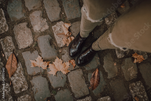 Girl smiling and throwing autumn leaves very happy