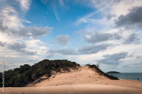 Landscape of the Santinho s dune near the beach of Praia dos ingleses on a beautiful sunny day with a big blue sky and clouds.