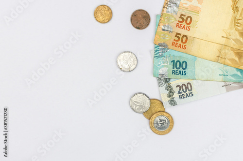new note of two hundred Brazilian reais with some parts in focus and a blurred part on top of the flag of Brazil