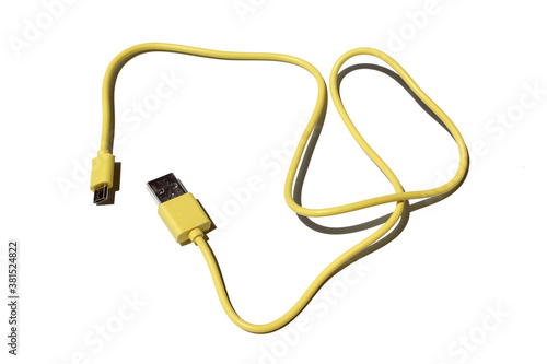 yellow USB cable on white background. USB and USB-mini cable connectors close-up. A patch cable or patch cord or patch lead.