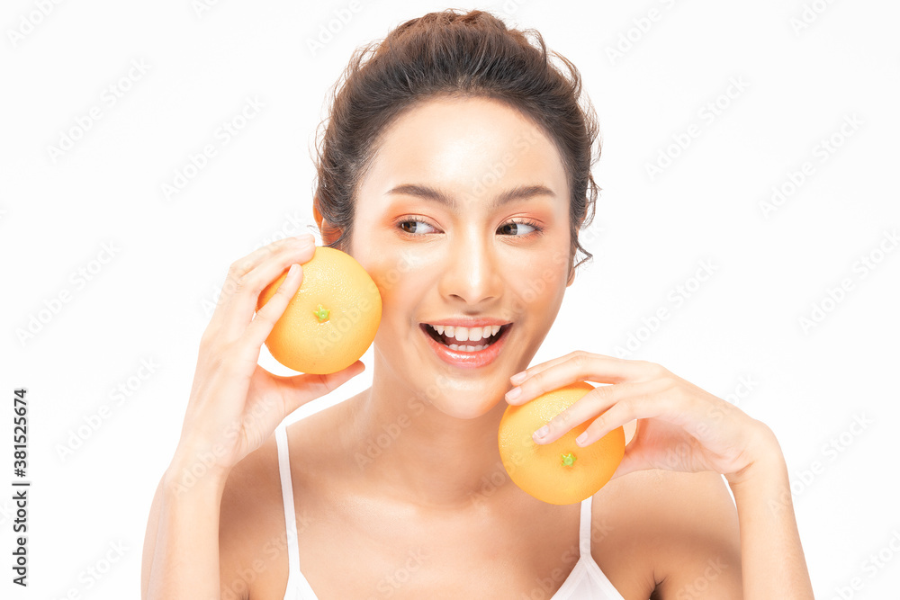 Beautiful Young Asian Woman Holding orange vitamin c smile feeling so happy and cheerful with healthy Clean and Fresh skin,isolated on white background,Beauty Cosmetics spa and treatment Concept Beautiful Young Asian Woman Holding orange vitamin c smile feeling so happy and cheerful with healthy Clean and Fresh skin,isolated on white background,Beauty Cosmetics spa and treatment Concept