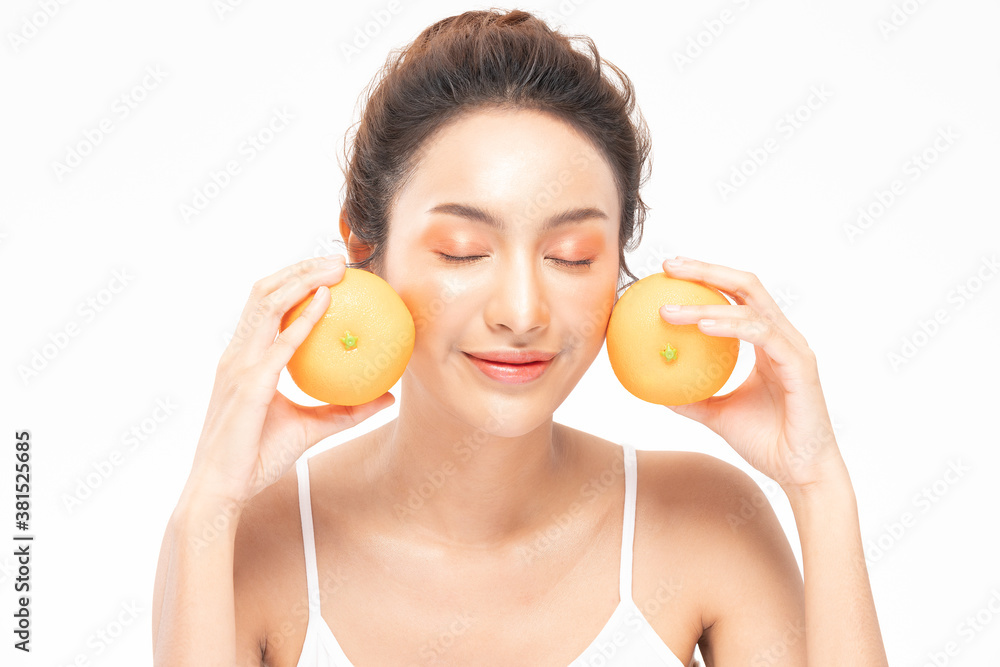 Beautiful Young Asian Woman Holding orange vitamin c smile feeling so happy and cheerful with healthy Clean and Fresh skin,isolated on white background,Beauty Cosmetics spa and treatment Concept Beautiful Young Asian Woman Holding orange vitamin c smile feeling so happy and cheerful with healthy Clean and Fresh skin,isolated on white background,Beauty Cosmetics spa and treatment Concept