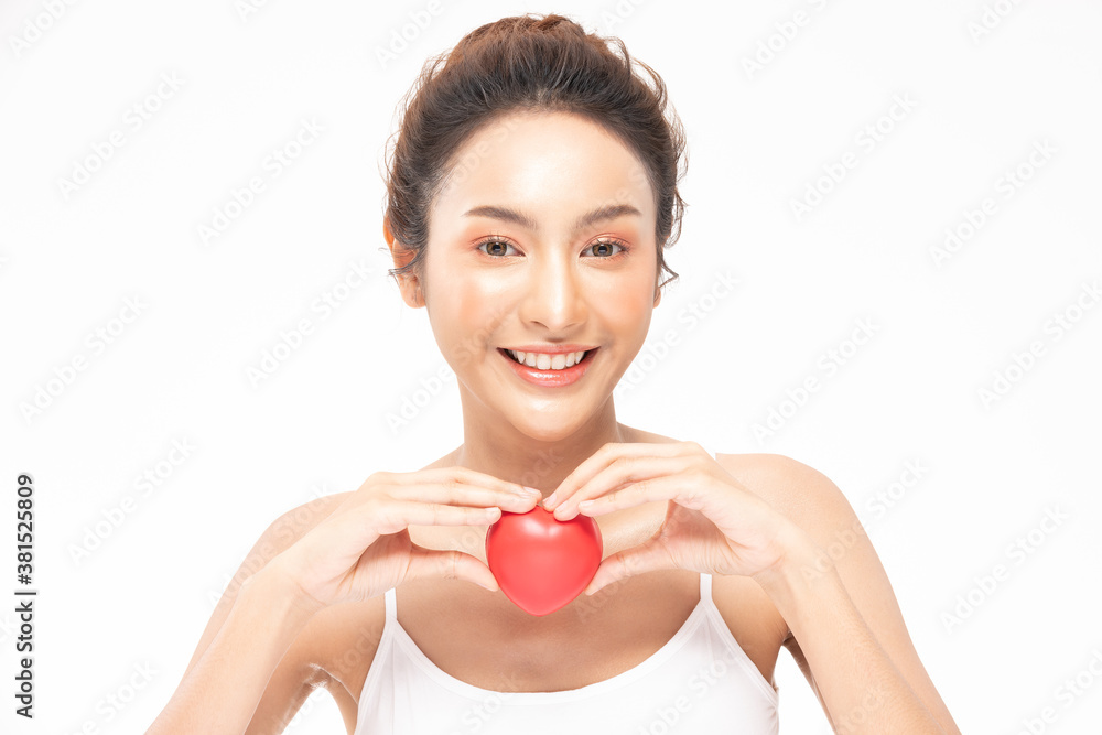 Beautiful Attractive Asian young woman smile with beautiful teeth and holding rubber heart feeling so happiness and confident,Isolated on white background,Beauty and Health care concept Beautiful Attractive Asian young woman smile with beautiful teeth and holding rubber heart feeling so happiness and confident,Isolated on white background,Beauty and Health care concept