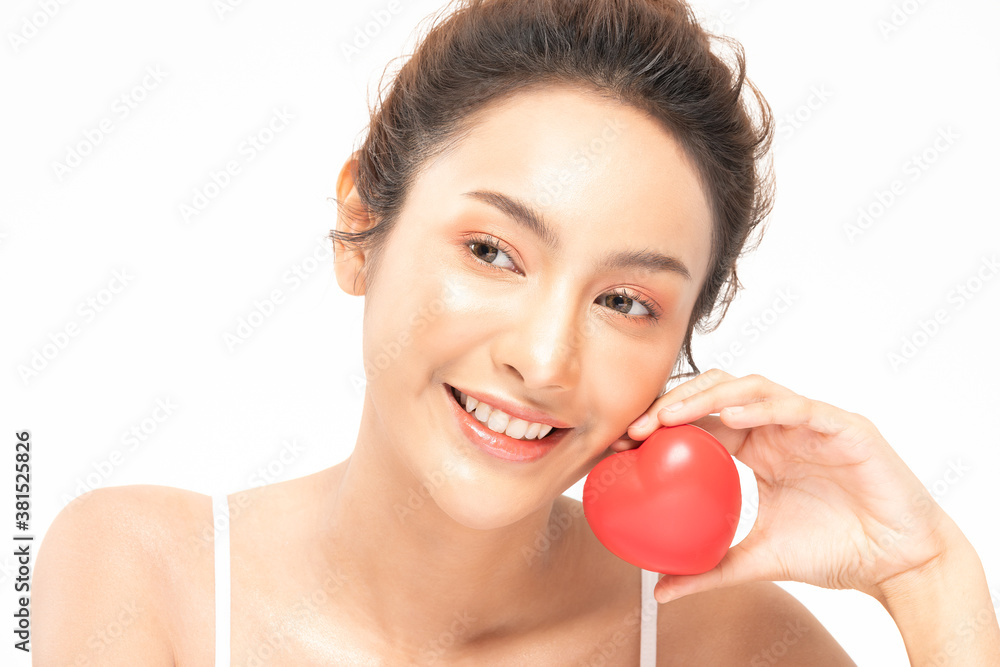 Beautiful Attractive Asian young woman smile with beautiful teeth and holding rubber heart feeling so happiness and confident,Isolated on white background,Beauty and Health care concept Beautiful Attractive Asian young woman smile with beautiful teeth and holding rubber heart feeling so happiness and confident,Isolated on white background,Beauty and Health care concept