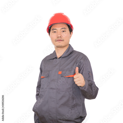 Thumbs up worker in red hard hat standing in front of white background photo