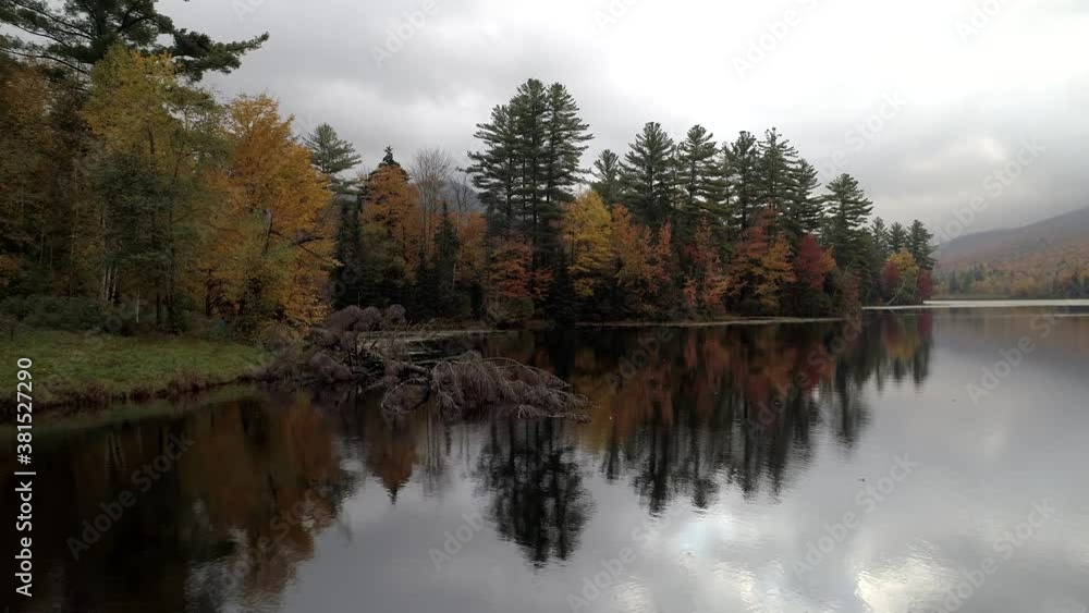 Aerial Drone - Fly Over Mirror Smooth Lake Towards Fall Trees in Vermont Aerial Drone - Fly Over Mirror Smooth Lake Towards Fall Trees in Vermont