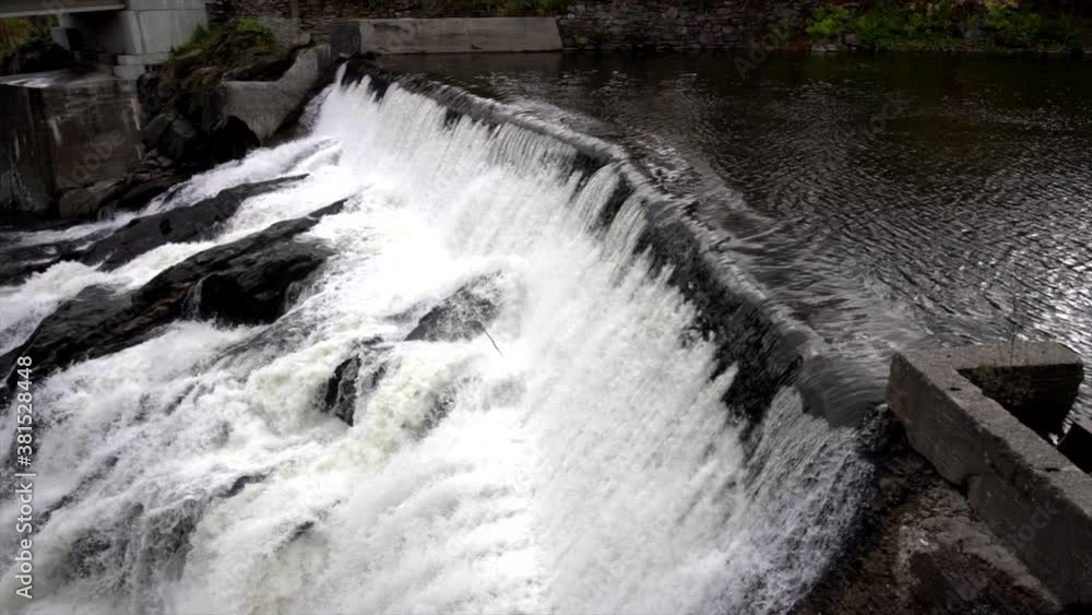 Slow Motion - Water Rushes Over Small Hydro Electric Dam 4K Slow Motion - Water Rushes Over Small Hydro Electric Dam 4K