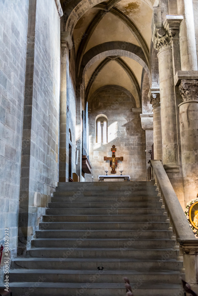 AREZZO, ITALY - OCTOBER 10, 2018: Strict and bright interior of the medieval church Santa Maria della Pieve in Arezzo, Tuscany, Italy