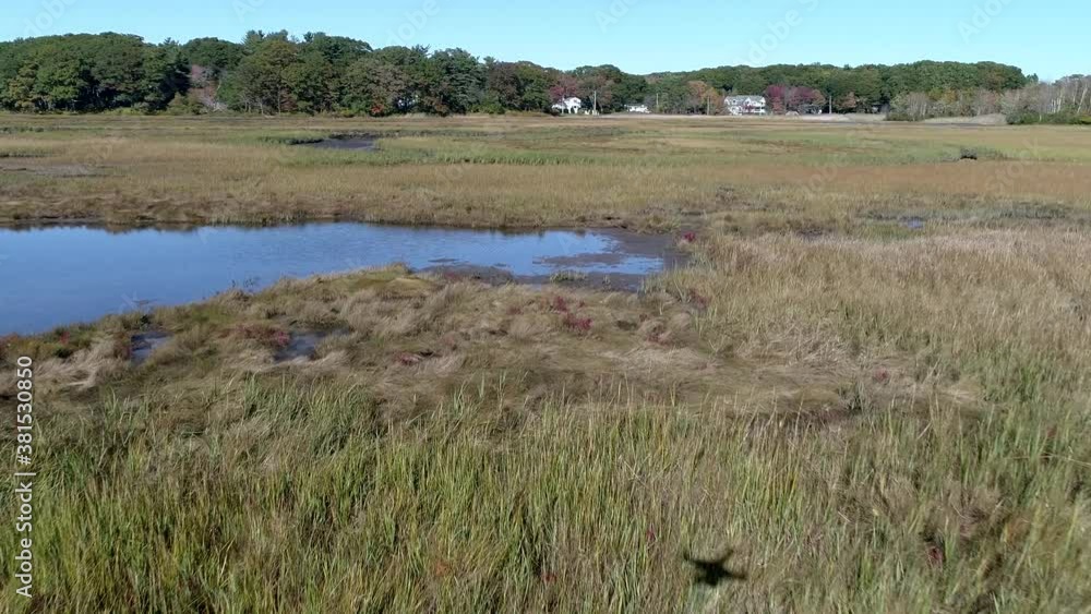 Aerial Drone - Fly Low Over Marsh Passing Over Small River With Drone Shadow In View 4K Aerial Drone - Fly Low Over Marsh Passing Over Small River With Drone Shadow In View 4K