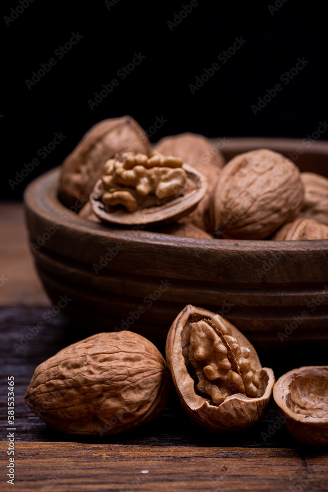 still life with Walnut kernels and whole walnuts on rustic old wooden table. still life with Walnut kernels and whole walnuts on rustic old wooden table.
