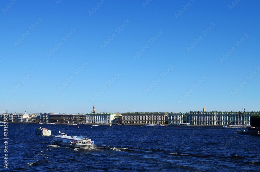 St. Petersburg view from the Neva River to the embankment along the Hermitage, along the river floats a meteor, a clear blue sky with a copy space