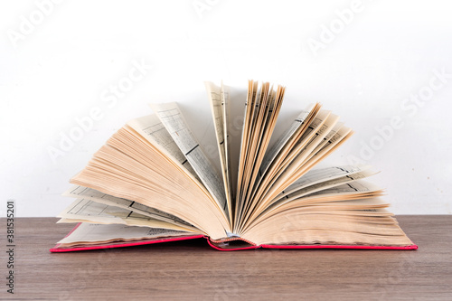 An open book on the table in front of white background