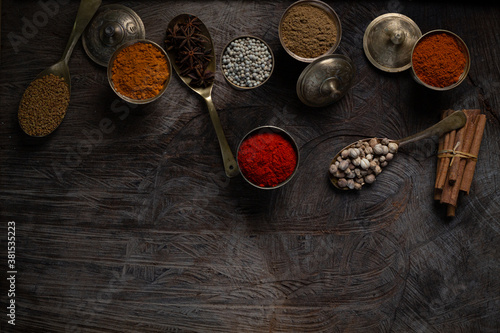 Condiment of indian food Spice garnish background on wood table top view. Seasoning of Asian organic herb cuisine flavour in kitchen board, chilli spicy taste concept