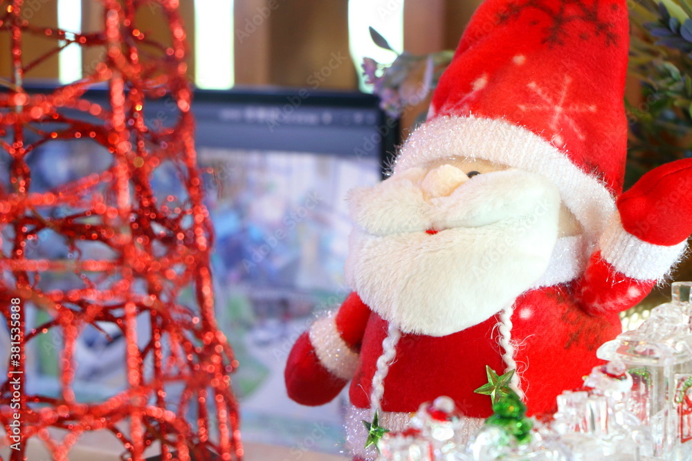 Fototapeta premium Close up santa claus fabric doll on Christmas environment background, have copy space for put text.