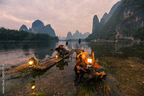 Chinese traditional living habits, images of traveling in Guilin, China, two fishermen relaxing on the Li River.